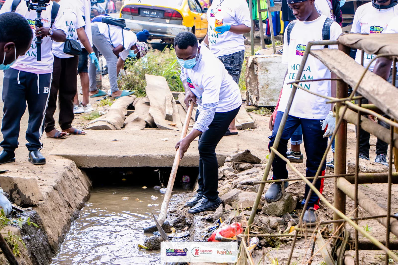 CIMFEST Cares volunteers cleaning a waterway