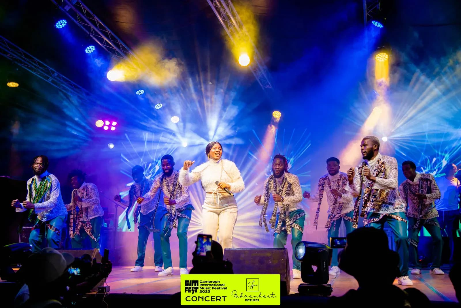 Live band performing under blue and yellow lights