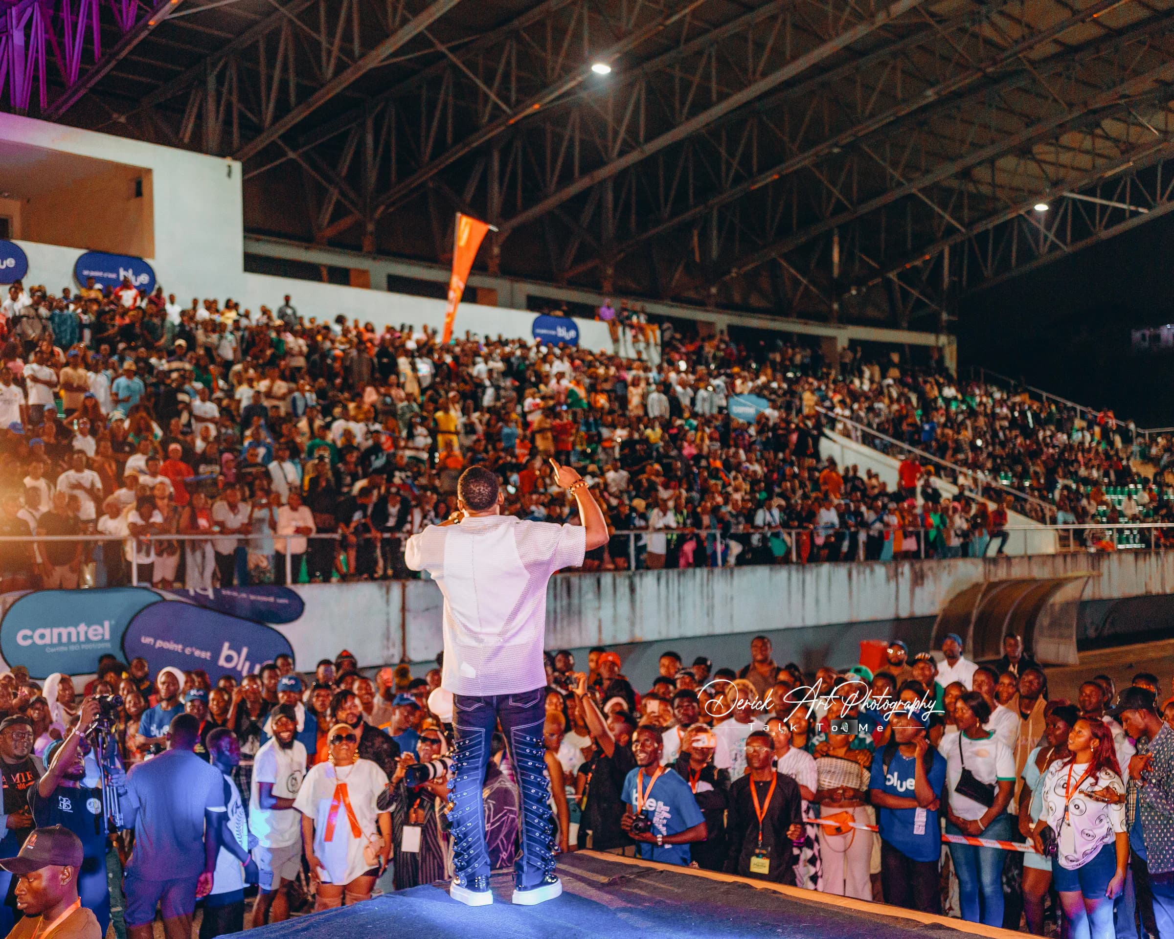 CIMFEST artist performing to a packed stadium crowd